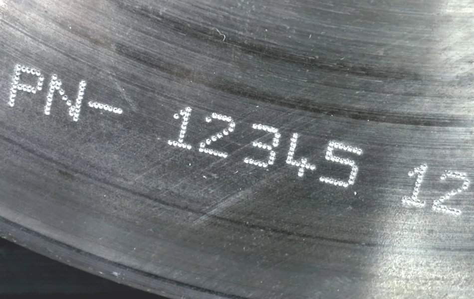 Dot peen marking on a machined metal component, showing deep, durable, and permanent engraved identification marks.